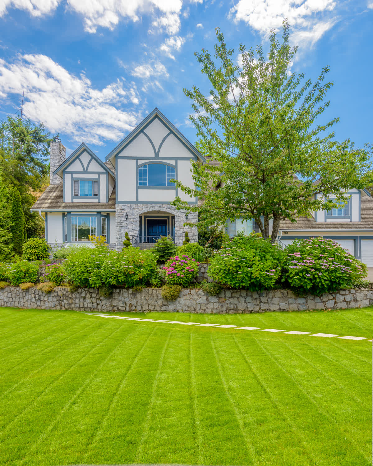 Luxury home front lawn by Brunner Landscape