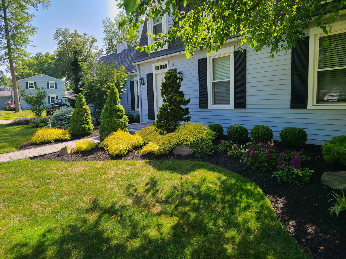 Fresh mulch bed with natural stone accents using materials available at Brunner Landscape in Sheffield Village, Ohio